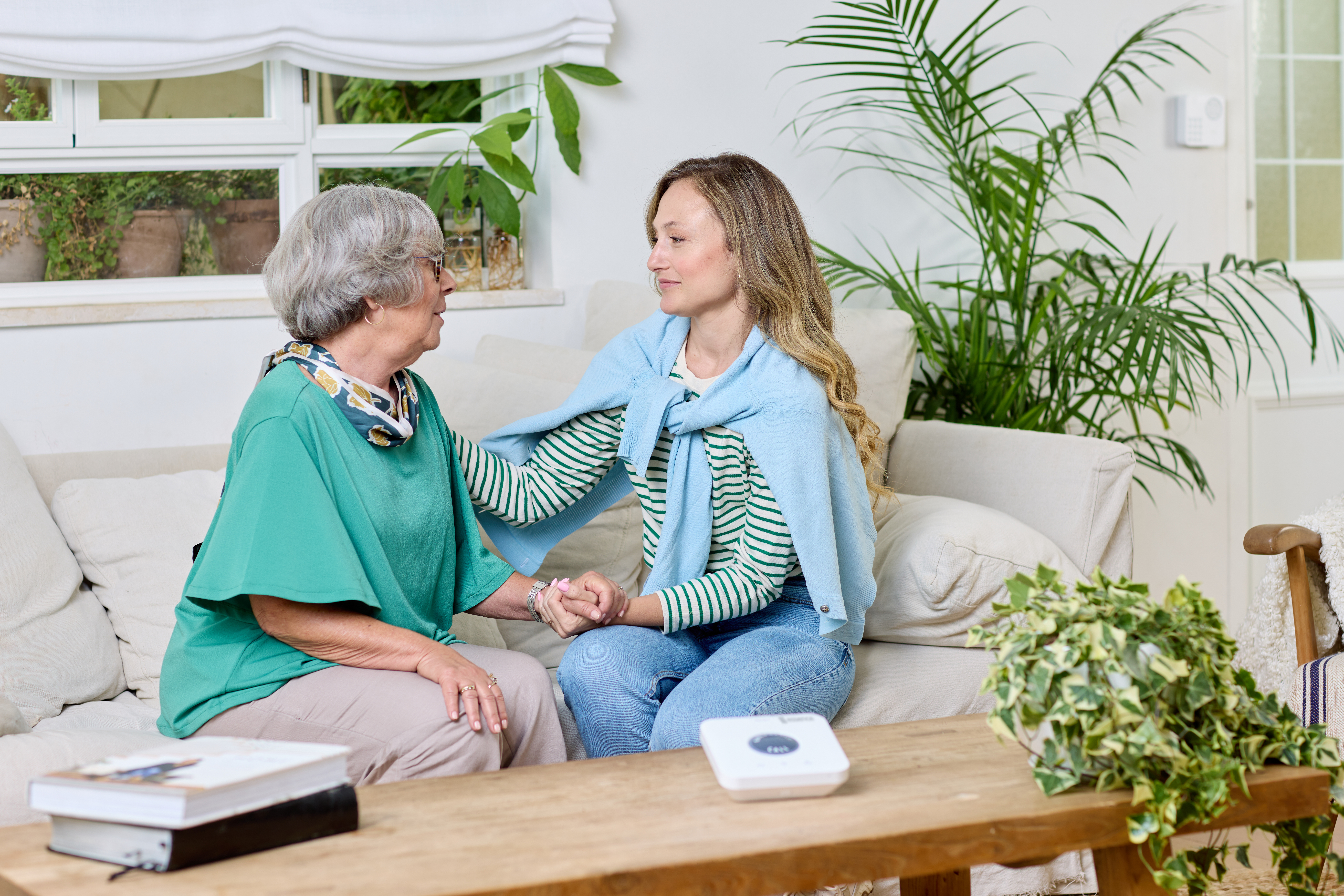 Two seniors at home with the hub on the coffee table